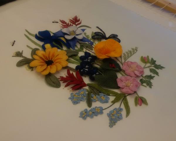 Raised embroidery work, to be accommodated within the box frame